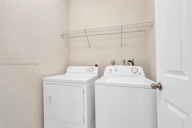 clothes washing area with washing machine and clothes dryer