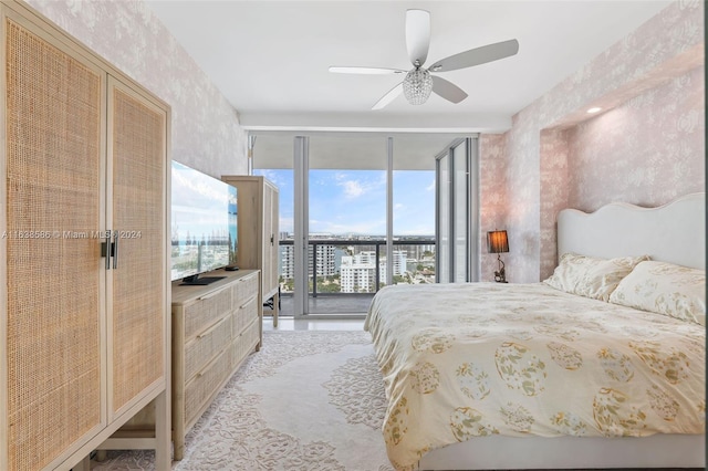 bedroom featuring ceiling fan, a wall of windows, and access to outside