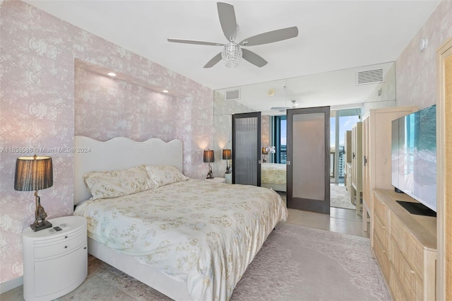 bedroom featuring wallpapered walls, a ceiling fan, and visible vents