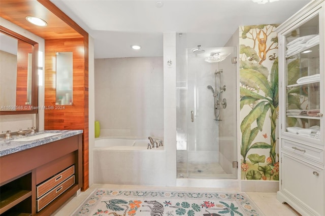 full bath featuring tile patterned floors, a stall shower, vanity, and a garden tub