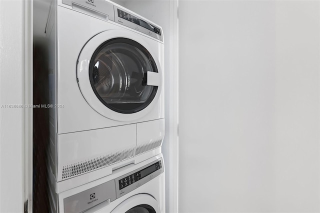 laundry room featuring stacked washer and clothes dryer and laundry area