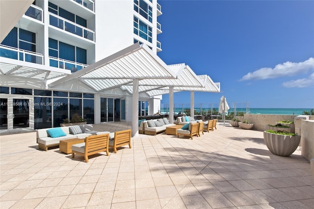 view of patio / terrace with a balcony, a water view, a pergola, and outdoor lounge area