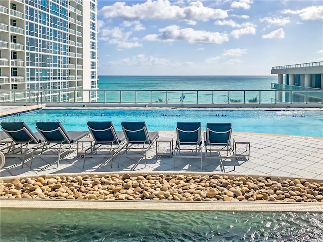 view of swimming pool with a water view