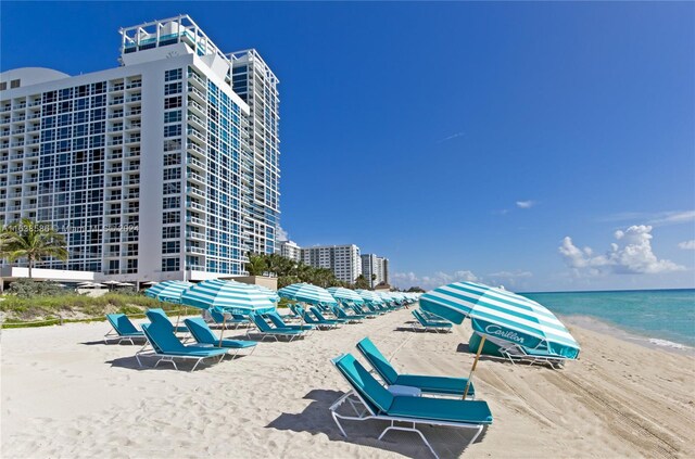 exterior space with a water view and a view of the beach