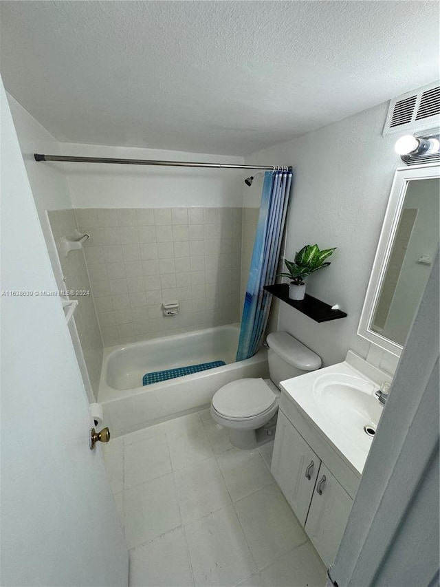 full bathroom featuring a textured ceiling, shower / bath combo with shower curtain, toilet, tile patterned floors, and vanity