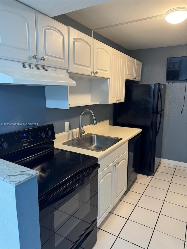 kitchen featuring light tile patterned flooring, sink, black appliances, and white cabinetry