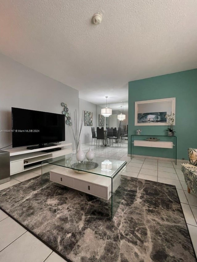 tiled living room featuring a textured ceiling