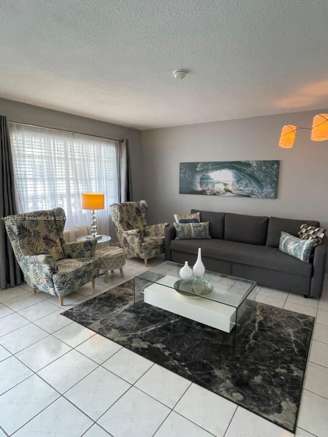 living room with light tile patterned floors and a textured ceiling