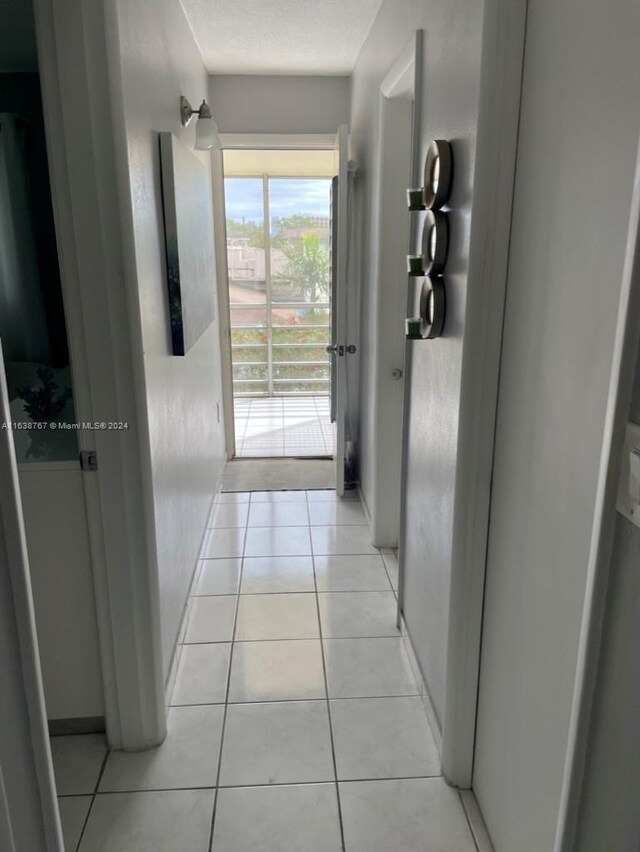 hall featuring light tile patterned flooring