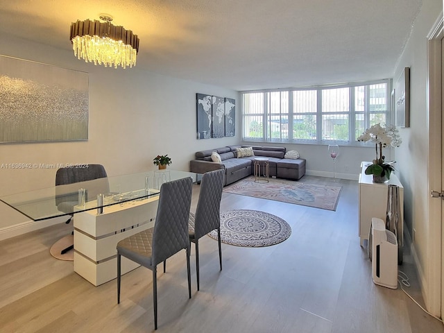 dining area with a notable chandelier and light wood-type flooring