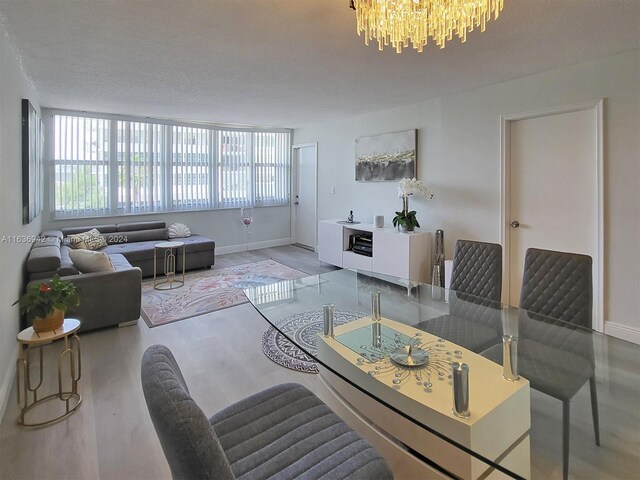 1825 S Ocean Dr Unit 206, Hallandale Beach, FL 33009 - living area with a chandelier, wood finished floors, and baseboards