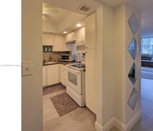 1825 S Ocean Dr Unit 206, Hallandale Beach, FL 33009 - kitchen with white appliances, dark countertops, backsplash, a sink, and recessed lighting