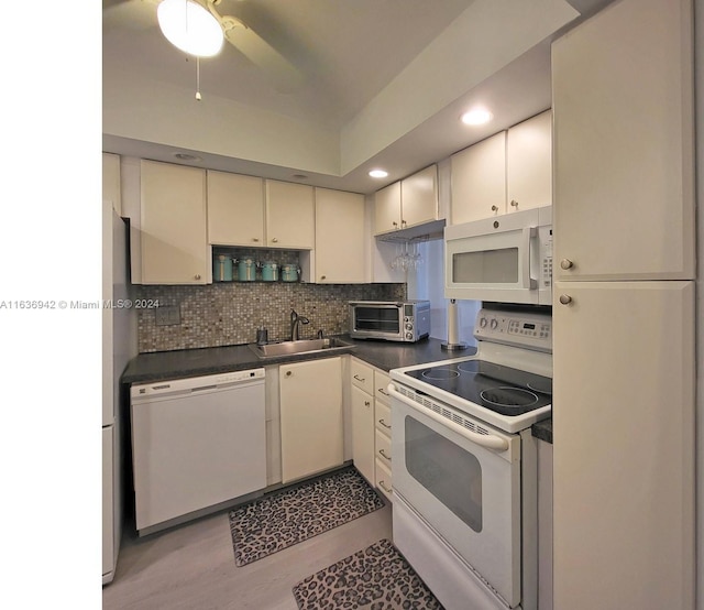 kitchen with ceiling fan, tasteful backsplash, light hardwood / wood-style floors, sink, and white appliances