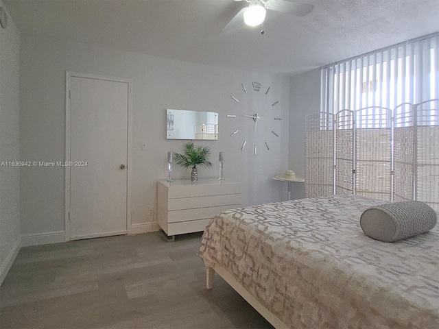 bedroom with ceiling fan and hardwood / wood-style flooring