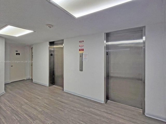 1825 S Ocean Dr Unit 206, Hallandale Beach, FL 33009 - unfurnished room featuring elevator, baseboards, and light wood-type flooring