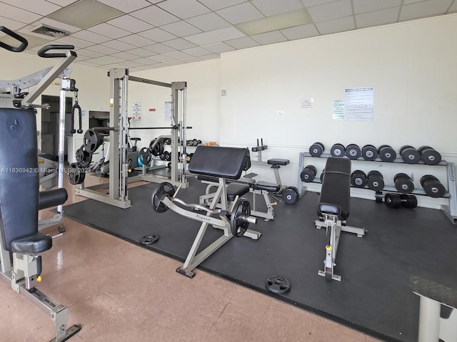 exercise room with a paneled ceiling