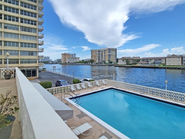 view of swimming pool featuring a water view