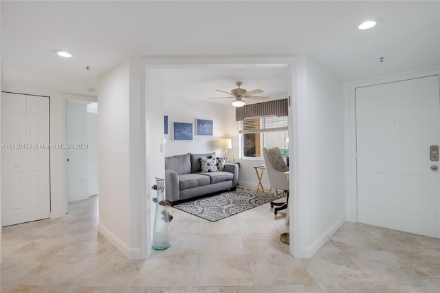 tiled living room featuring ceiling fan