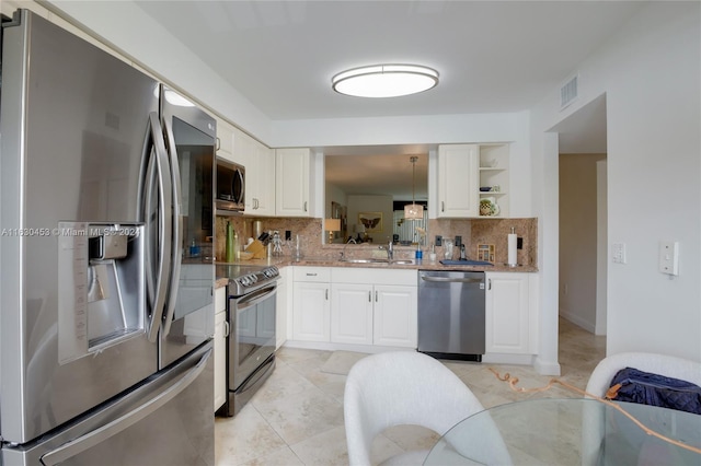 kitchen featuring stainless steel appliances, tasteful backsplash, sink, light stone counters, and light tile patterned flooring