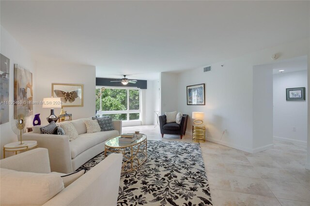 living room with ceiling fan and light tile patterned flooring