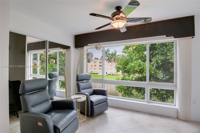 sitting room with ceiling fan and light tile patterned floors