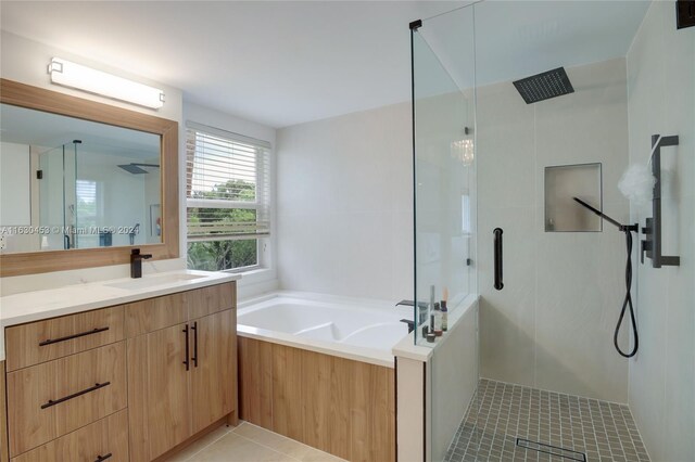 bathroom with tile patterned flooring, vanity, and independent shower and bath