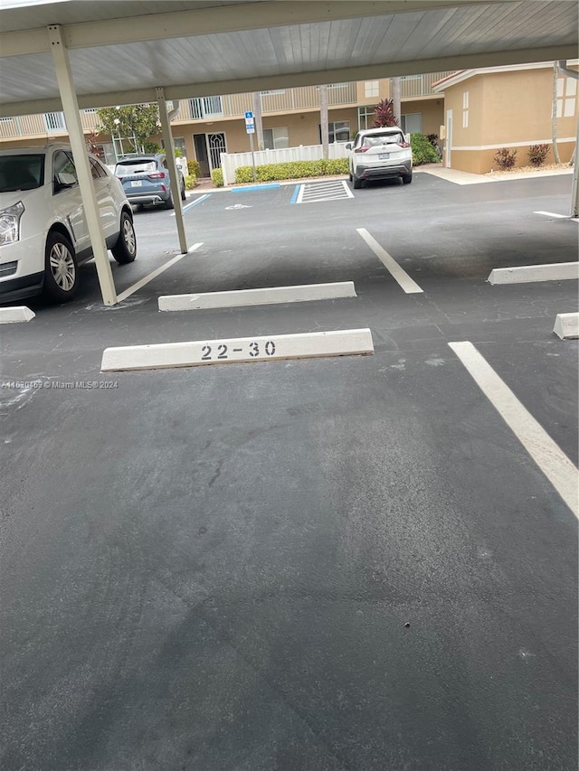 view of parking / parking lot with a carport