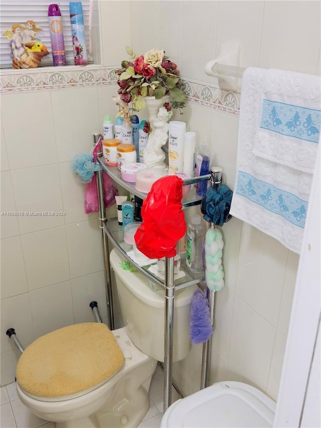 bathroom featuring tile walls, toilet, and tile patterned floors