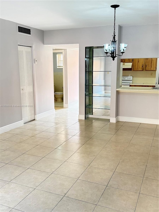 440 E 23rd St Unit 1219, Hialeah, FL 33013 - unfurnished dining area featuring light tile patterned floors, a chandelier, and baseboards