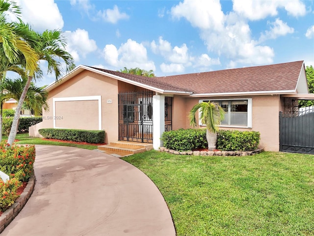 ranch-style home with a garage and a front lawn