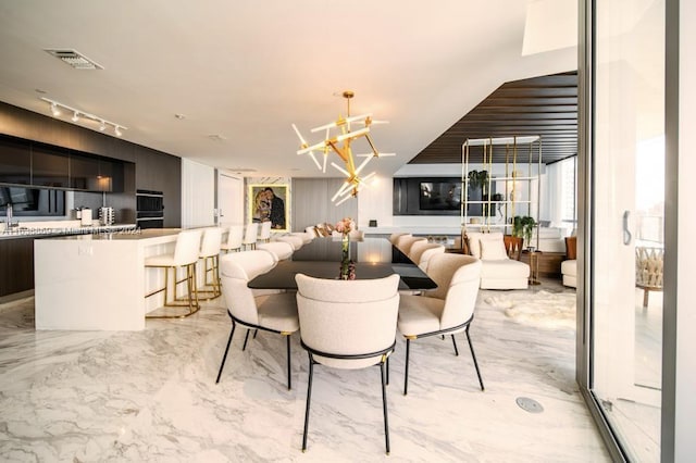 851 NE 1st Ave Unit 4811, Miami, FL 33132 - dining room with a chandelier and light marble finish flooring