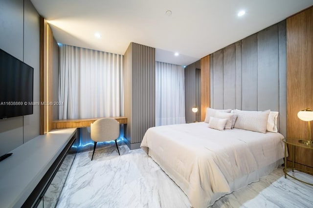 bedroom featuring wooden walls