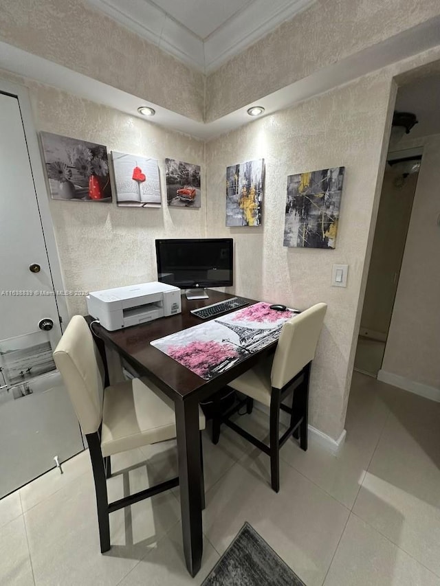 home office with light tile patterned flooring and crown molding