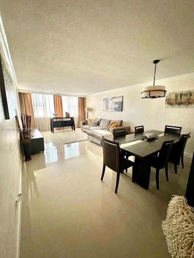 dining room with a textured ceiling and crown molding