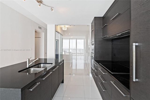 kitchen with sink, decorative backsplash, light tile patterned floors, and appliances with stainless steel finishes