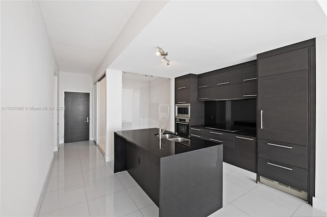 kitchen with light tile patterned floors, stainless steel appliances, and sink