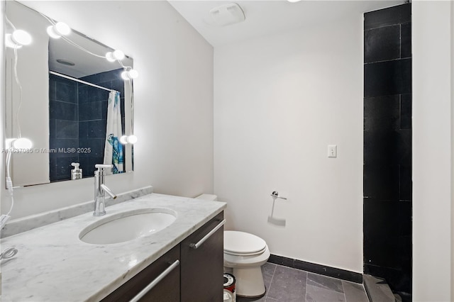 bathroom featuring vanity, curtained shower, and toilet