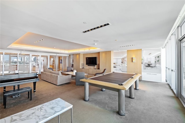 game room featuring carpet flooring and a tray ceiling