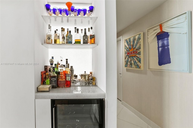 bar featuring wine cooler and tile patterned floors