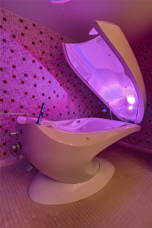 bathroom with tasteful backsplash, tile patterned floors, and tile walls