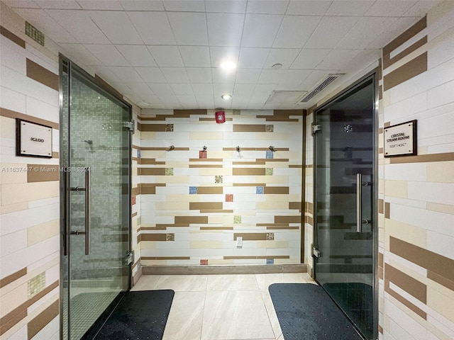 bathroom featuring tile patterned floors and a shower with door