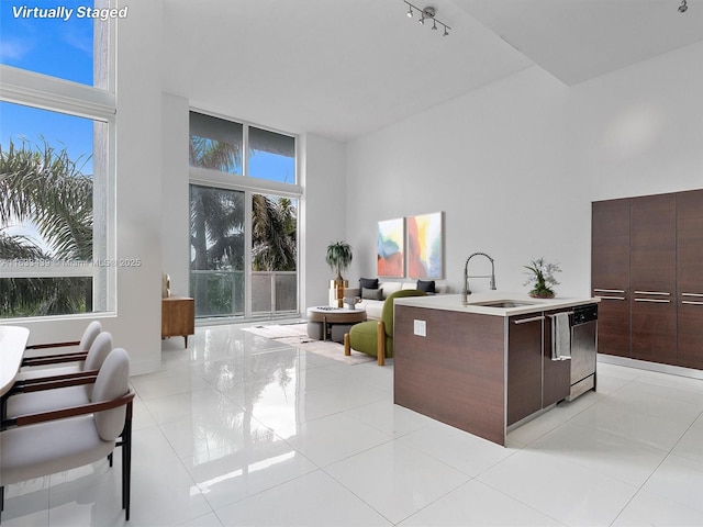 interior space with light tile patterned floors, sink, and a wealth of natural light