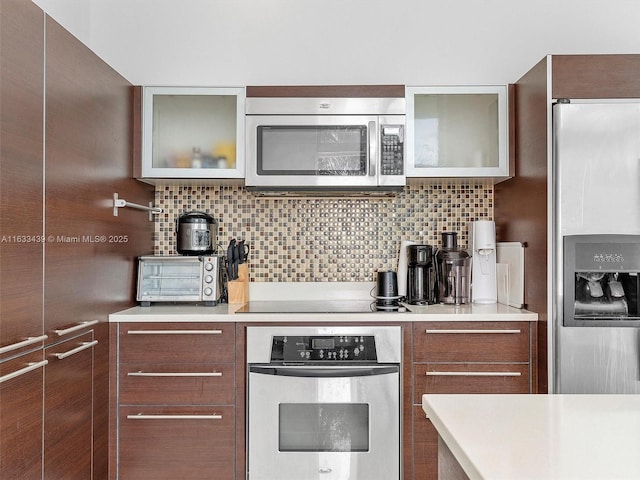 kitchen with backsplash and appliances with stainless steel finishes