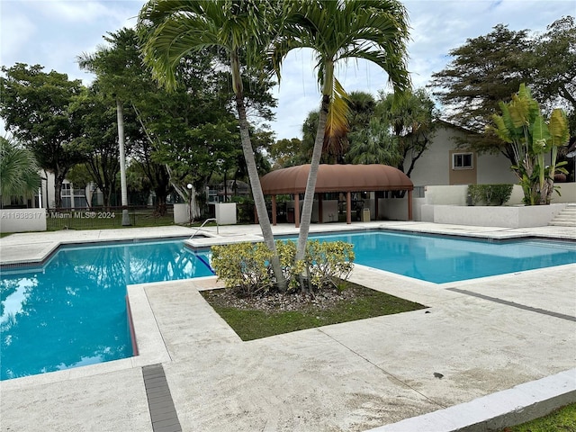 view of swimming pool with a patio area