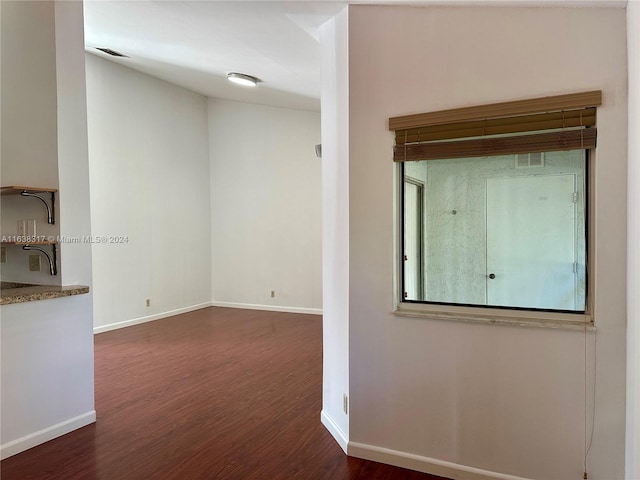 unfurnished room featuring dark hardwood / wood-style floors