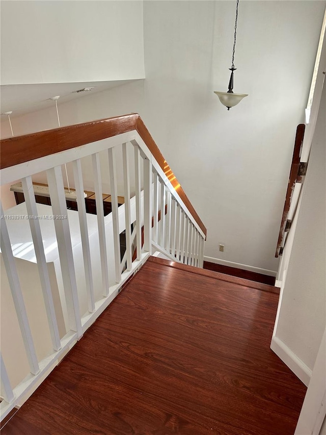 staircase with hardwood / wood-style floors