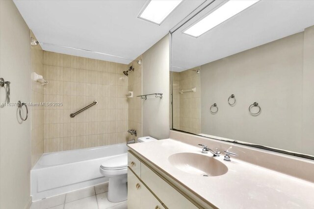 full bathroom with tiled shower / bath, vanity, toilet, and tile patterned flooring