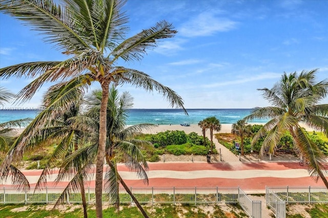 view of water feature with a view of the beach and fence