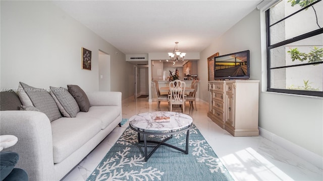 living room with a notable chandelier, light tile patterned floors, and a wealth of natural light