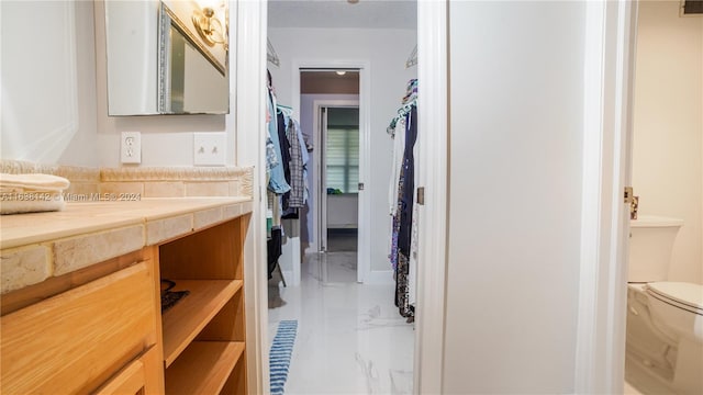 bathroom with vanity, toilet, and tile patterned flooring